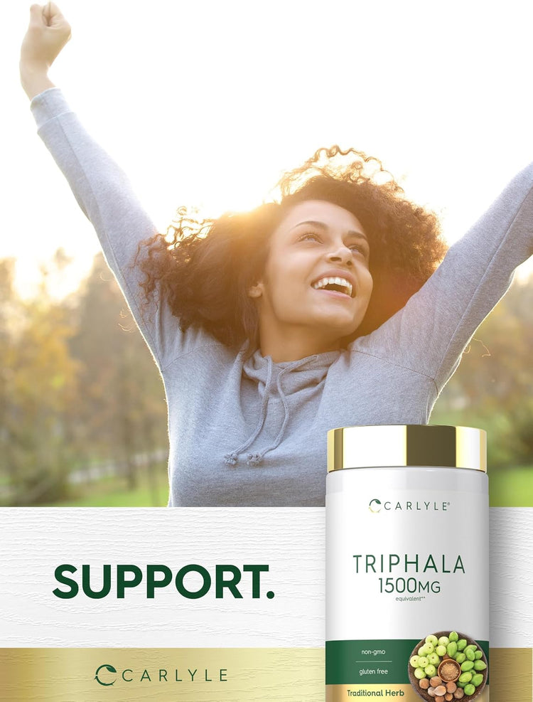 A young adult woman smiles with arms raised outdoors, next to a Carlyle Triphala bottle.