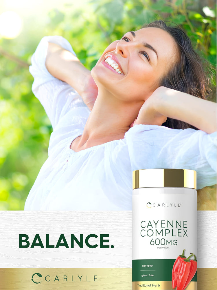 A woman smiles at the sun outdoors, holding a Carlyle Cayenne Complex 600 mg bottle.