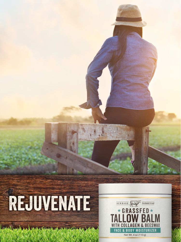 An adult woman sits on a wooden fence gazing at a field, holding a jar of Tallow with Collagen Balm.