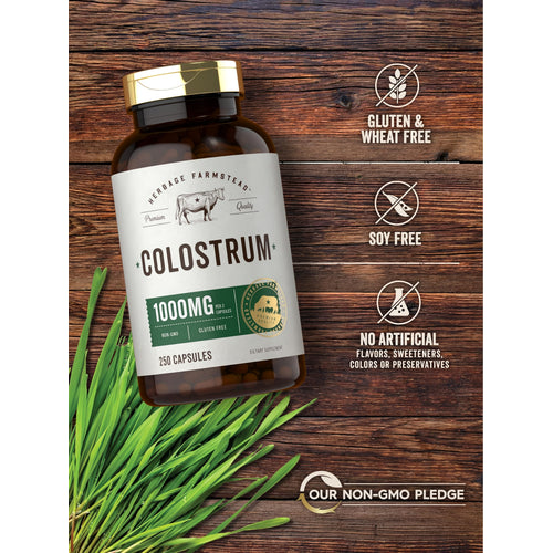 View 5 Colostrum bottle with icons indicating Gluten & Wheat Free, Soy Free, No Artificial Additives, and Our Non-GMO Pledge.