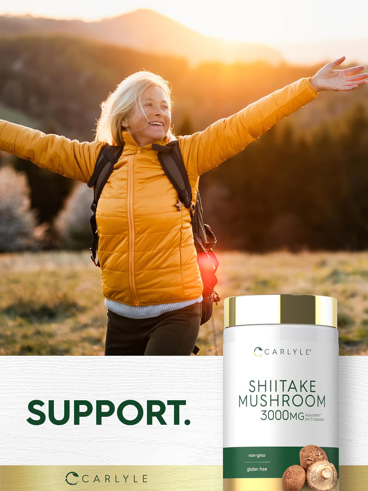 Senior woman enjoying a hike, arms outstretched, next to a Carlyle Shiitake Mushroom bottle.