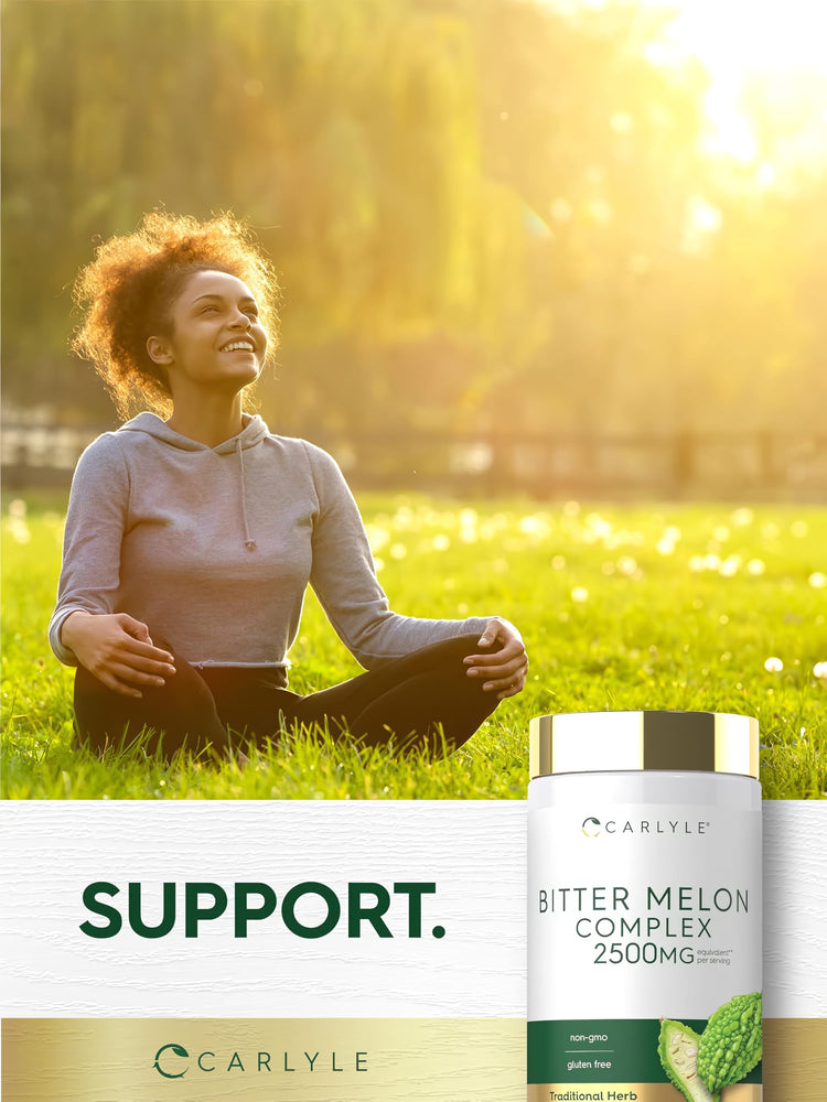 Young adult woman sits cross-legged in a grassy field, smiling upward with a Carlyle Bitter Melon Complex bottle beside her.