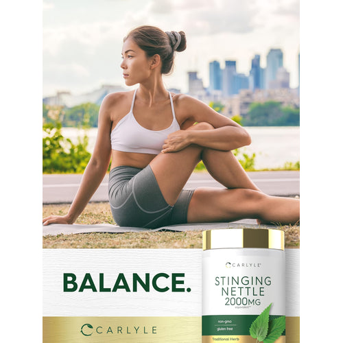 View 6 A young woman practices outdoor yoga seated with a Carlyle Stinging Nettle 2000MG bottle beside her.
