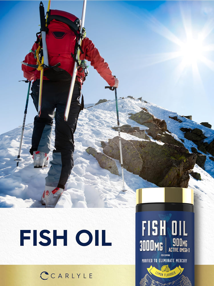 Person hiking a snowy mountain carrying ski gear and trekking poles, alongside a bottle of Carlyle Fish Oil.