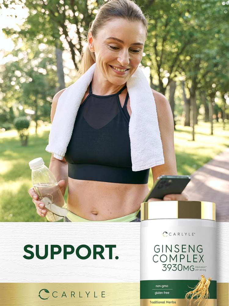 A woman in activewear smiles while taking a break outdoors with a jar of Ginseng Complex.