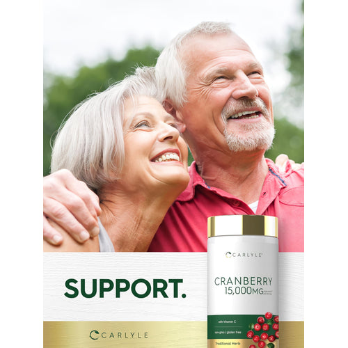 View 6 Elderly couple smiling and embracing outdoors with a Carlyle Cranberry supplement bottle nearby.