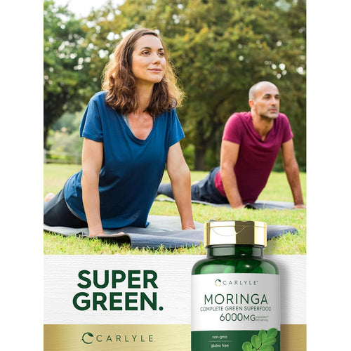 View 6 Two people practice yoga outdoors next to a bottle of Moringa.