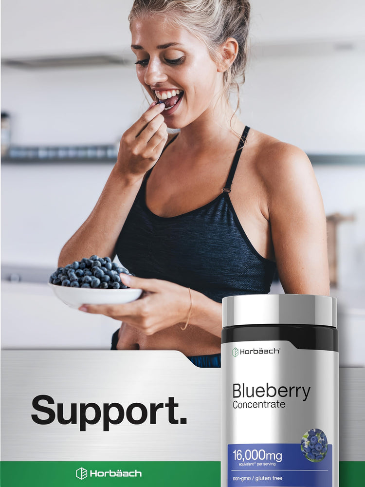 Young adult woman in sportswear smiling while eating a blueberry from a bowl, with a Horbäach Blueberry Concentrate bottle.