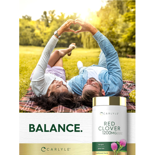 View 6 A young couple on a blanket makes a heart with their hands, featuring a Carlyle Red Clover bottle.