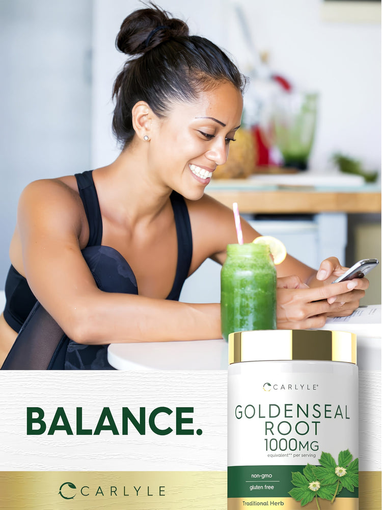 A young woman smiles at her phone beside a green smoothie and a bottle of Carlyle Goldenseal Root.