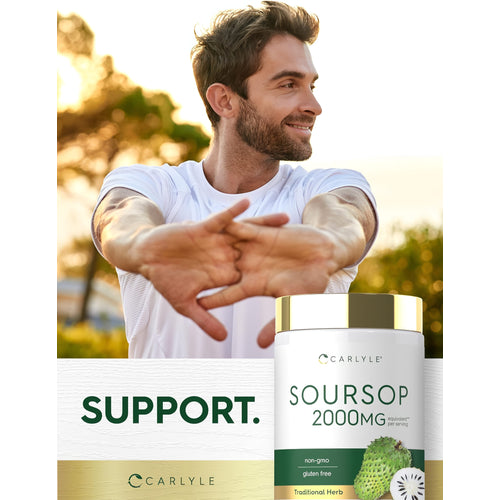 View 6 A smiling man in his 30s-40s stretches his arms outdoors, standing beside a Soursop bottle.