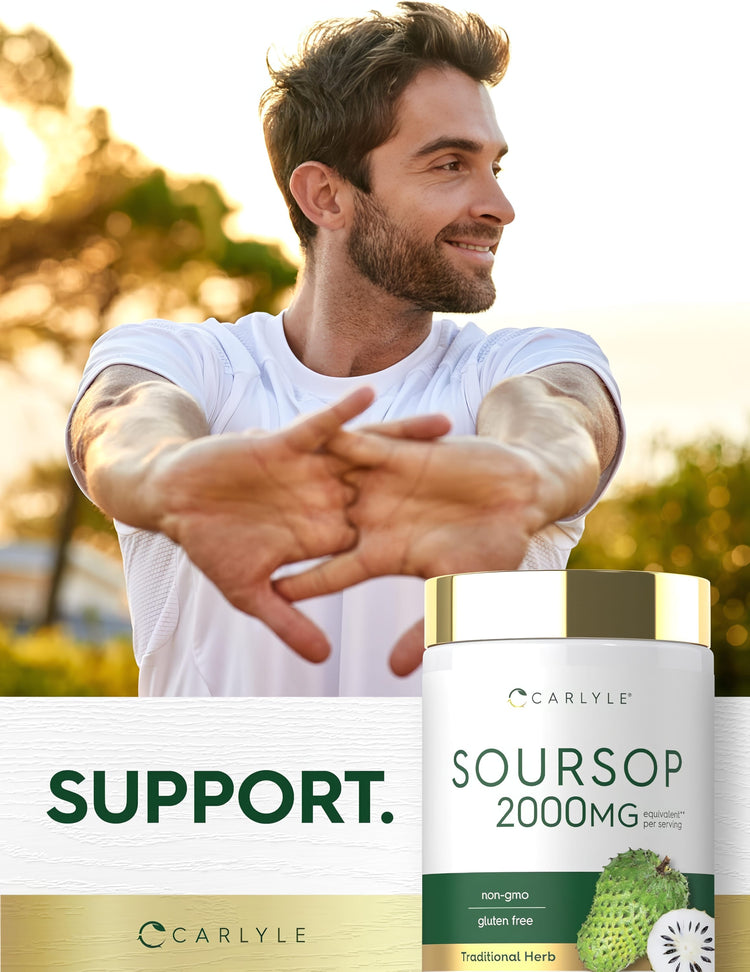 A smiling man in his 30s-40s stretches his arms outdoors, standing beside a Soursop bottle.