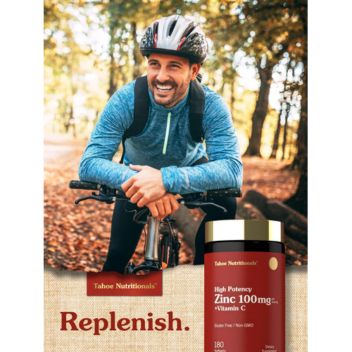 View 6 A middle-aged man cycling outdoors, smiling while holding a bottle of Tahoe Nutritionals Zinc + Vitamin C.
