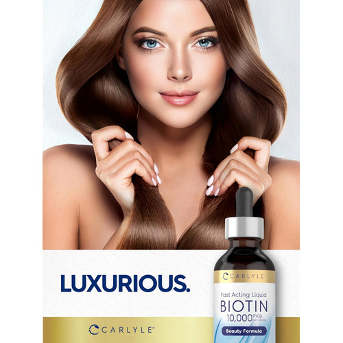 View 6 Young woman holds her long brown hair with a Carlyle Biotin bottle in her hand.