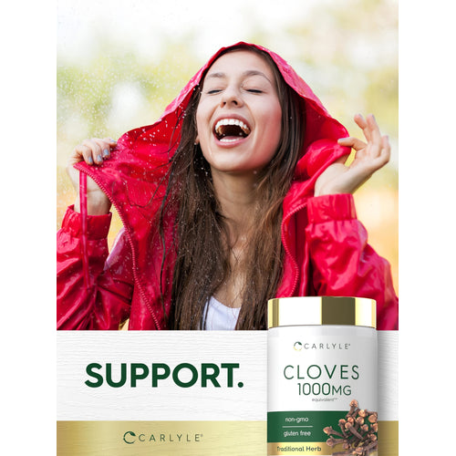 View 6 Young woman smiling in a red raincoat during rain, holding a Cloves 1000mg supplement bottle.