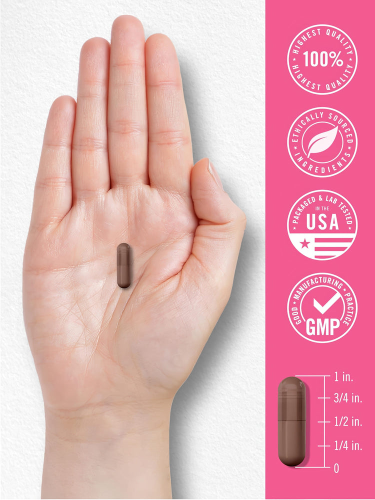 A brown capsule in a hand, about 3/4 inch tall, with an adjacent scale for size comparison.