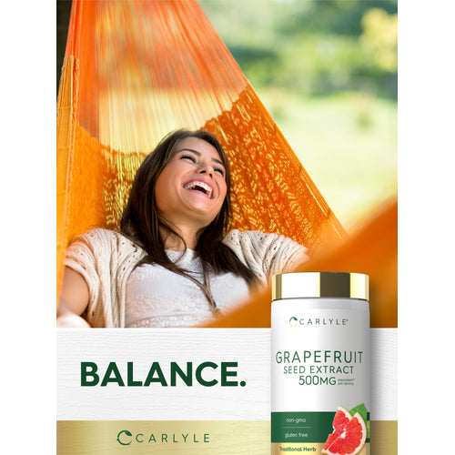 View 12 Lifestyle image of a smiling woman relaxing in an orange hammock with Grapefruit Seed Extract 500MG bottle and graphic stating BALANCE.