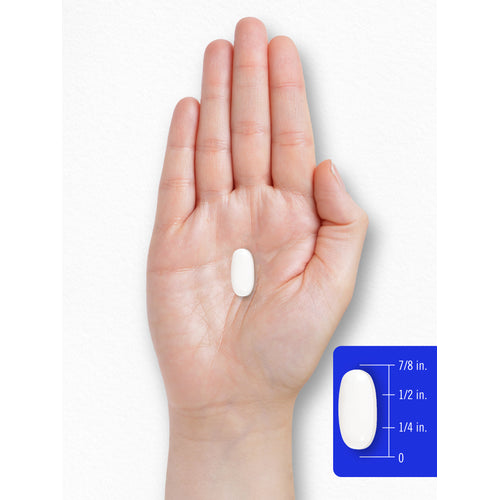 View 4 A white oval pill is shown on a hand next to a scale, measuring its length as seven-eighths of an inch.