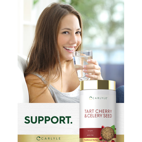 View 14 A young woman smiles and drinks water next to a Carlyle Tart Cherry & Celery Seed bottle.