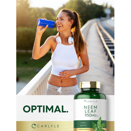 View 10 A smiling young woman in activewear drinks from a water bottle, with a Neem Leaf supplement bottle visible.