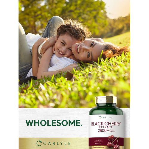 View 12 Lifestyle image of an adult and child lying together on grass with Carlyle Black Cherry Extract 2800 mg bottle and graphic stating WHOLESOME.