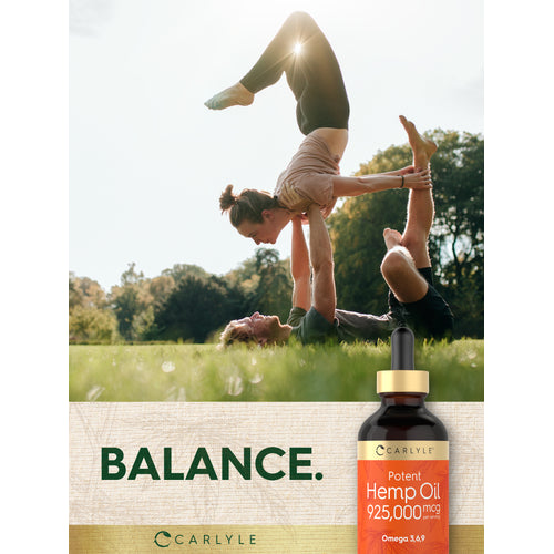 View 12 Two young adults perform an acroyoga pose in a sunny park with a Carlyle Potent Hemp Oil bottle.