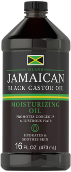 Bottle of Jamaican Black Castor Oil, 16 FL.OZ. (473 mL), resting on hand for scale.
