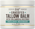 A jar of Grassfed Tallow Balm with Collagen and Beeswax, Net Wt. 4 OZ (113 g), resting on a hand for scale.