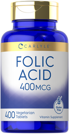 Hand holding a scale measuring 400 MCG Folic Acid Vegetarian Tablets, showing bulk quantity.