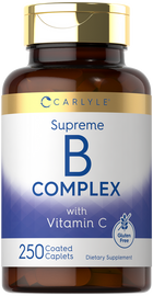 Carlyle Supreme B Complex with Vitamin C, 250 coated caplets, on a hand scale.