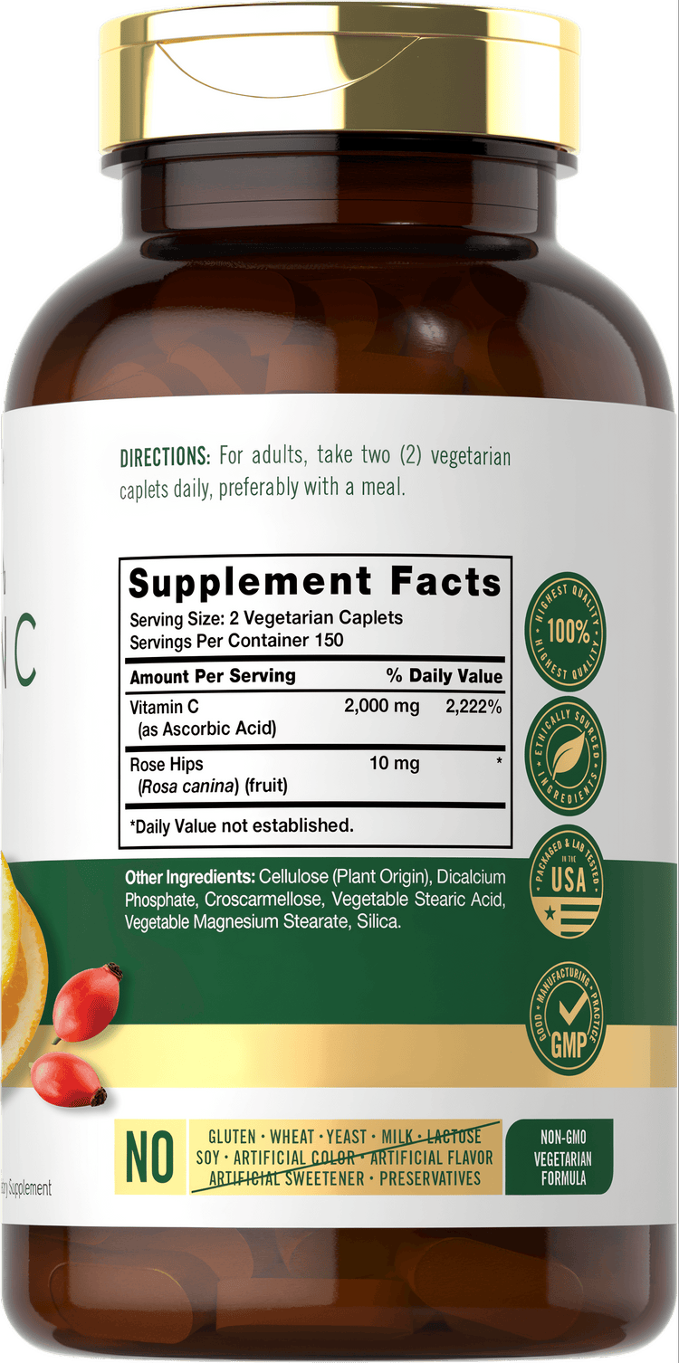 Carlyle Vitamin C 1000 mg vegetarian caplets on a hand scale showing their bulk size and quantity.